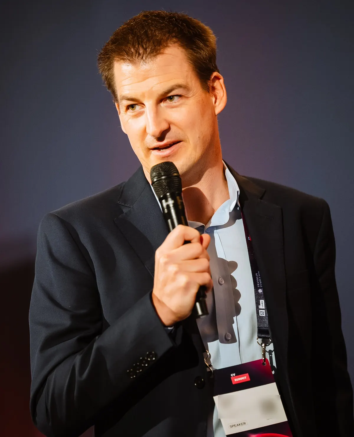 Jonas Epp speaking with a microphone during his keynote at CV Summit 2026